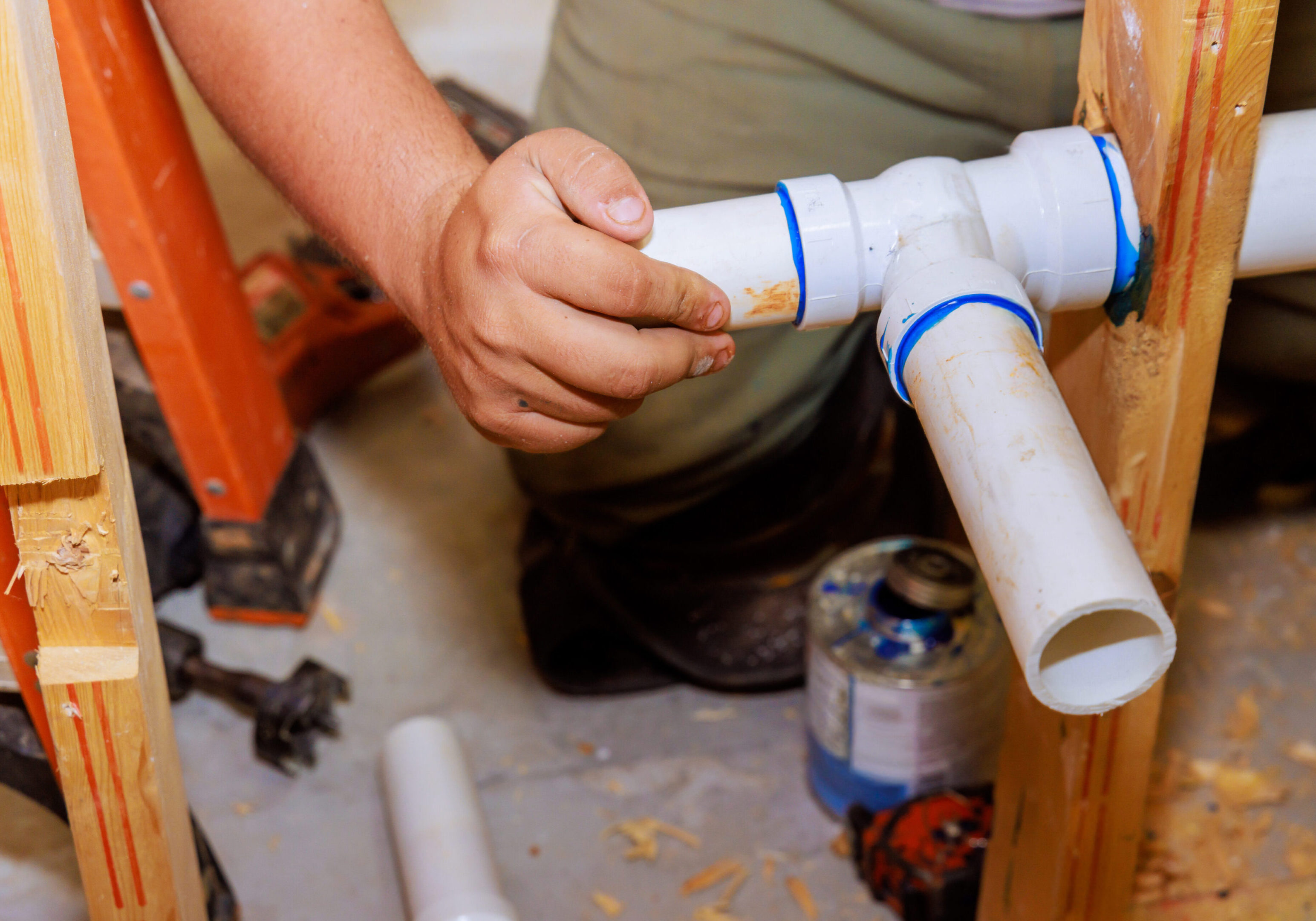 Using glue to join plastic PVC pipes, plumber uses